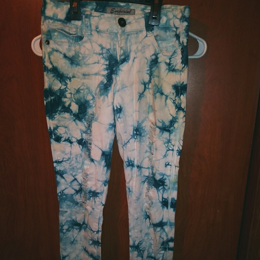Imperial blue-green blotches over white jeans